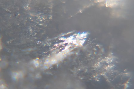 Snow crystals glittering in strong direct sunlight 49 - 50 - cropped