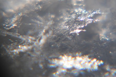 Snow crystals glittering in strong direct sunlight 40 - cropped