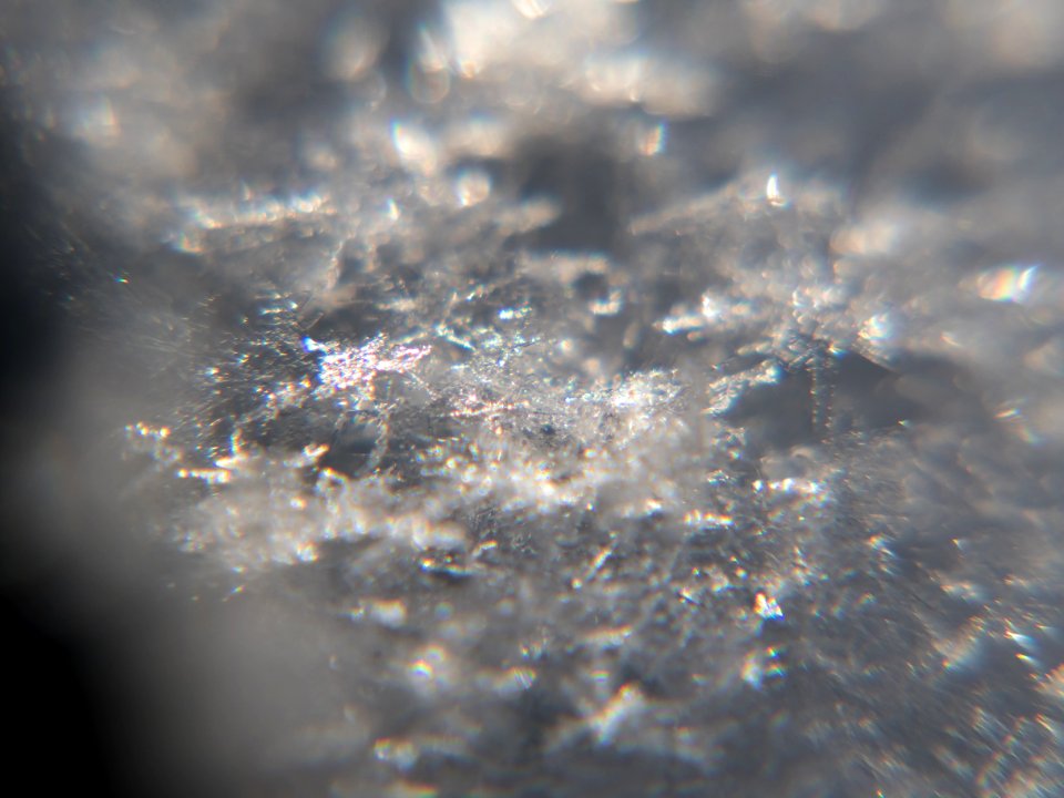 Snow crystals glittering in strong direct sunlight 09