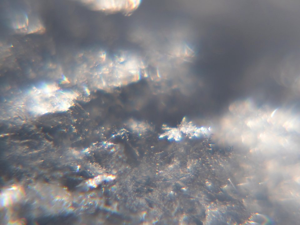 Snow crystals glittering in strong direct sunlight 24