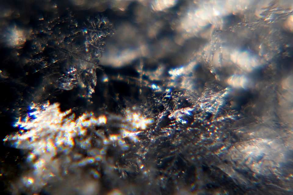 Snow crystals glittering in strong direct sunlight 29 - cropped - high contrast