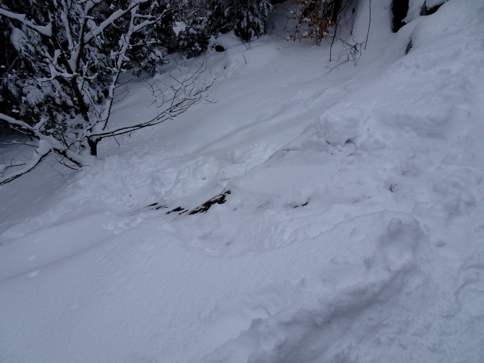 Slide path down steep mountain rock