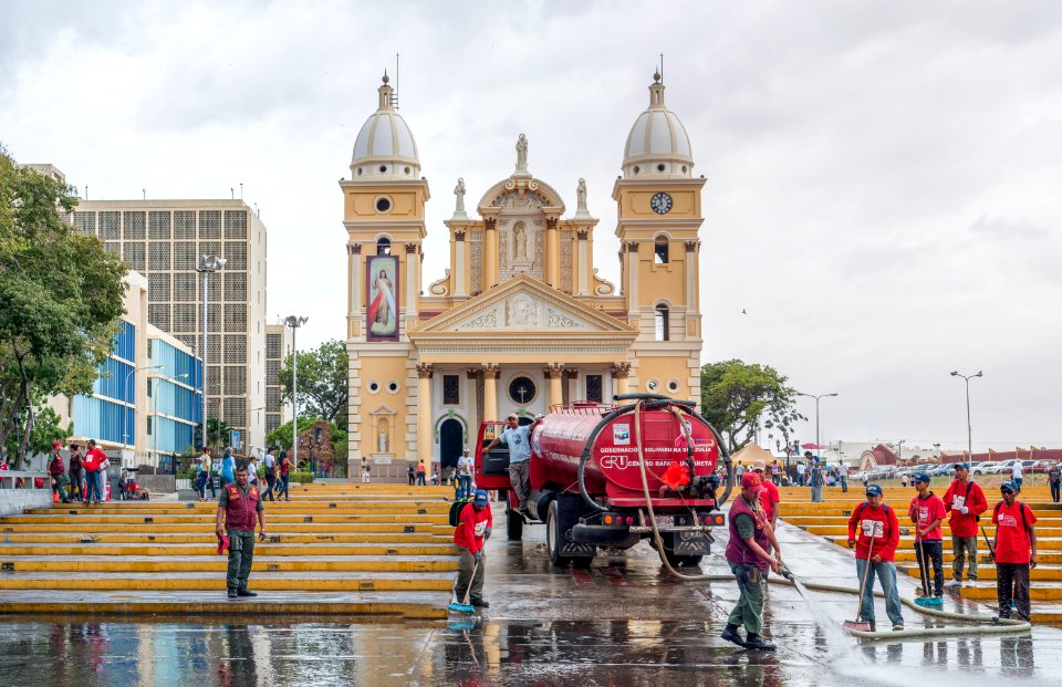 Soldiers of the National Guard, cleaning sidewalks of the square Chiquinquira Basilica