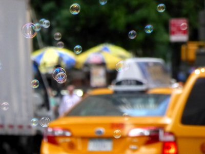 Soap-Bubbles-in-front-of-a-taxi photo