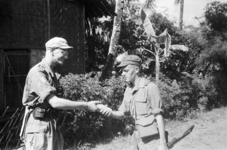 Soemedang Zuiveringsacties van 3-4 RI Een militair overhandigt iets aan een a, Bestanddeelnr 495-3-5