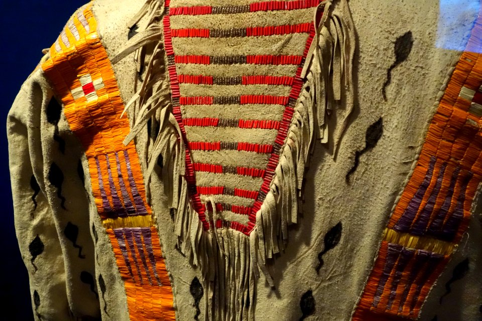 Shirt with tadpole design, Kainai, early 1900s, view 2, elk hide, porcupine quills, natural dyes, weasel pelts - Glenbow Museum - DSC00967