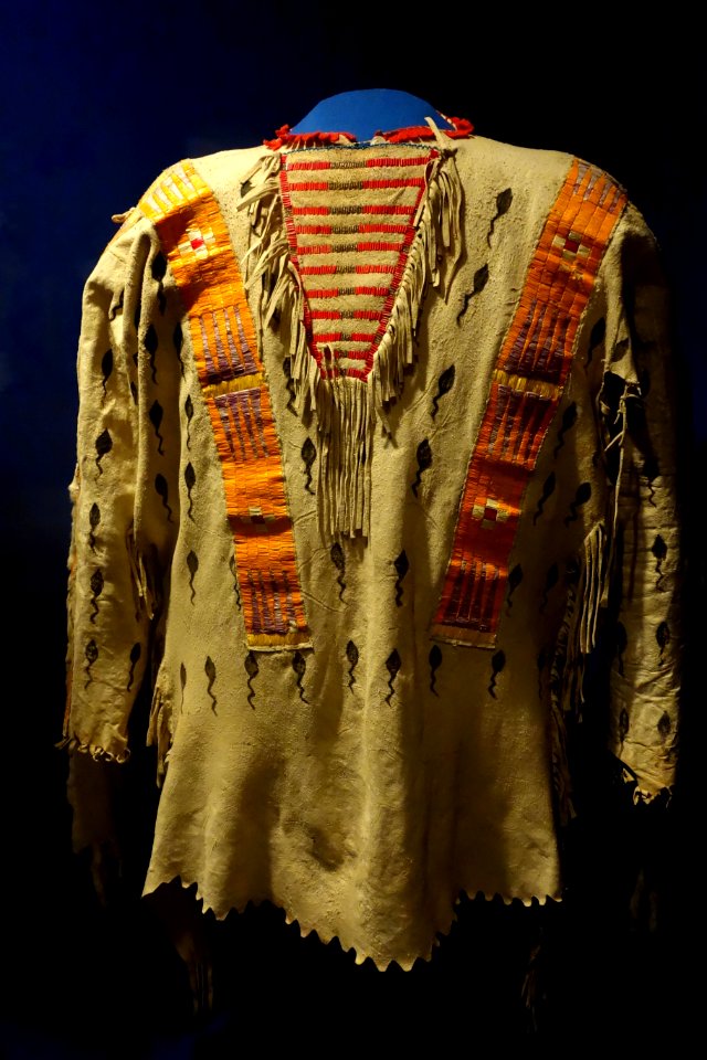 Shirt with tadpole design, Kainai, early 1900s, view 1, elk hide, porcupine quills, natural dyes, weasel pelts - Glenbow Museum - DSC00964
