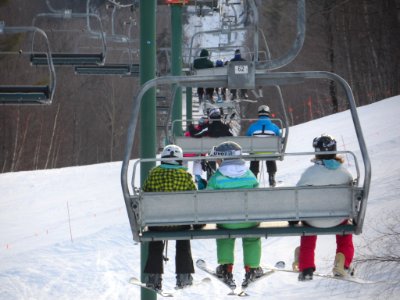 Skiers on chairlift photo