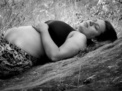Mother outdoors lying