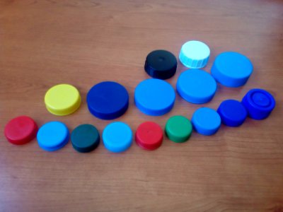 Sixteen plastic bottle lids