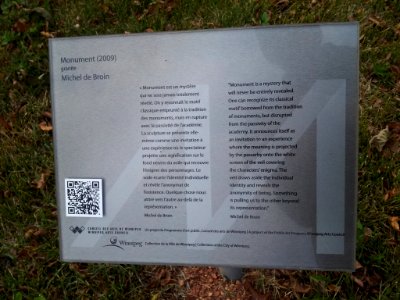Signage for "Monument" granite sculpture at Jardin de sculptures in Winnipeg, Manitoba