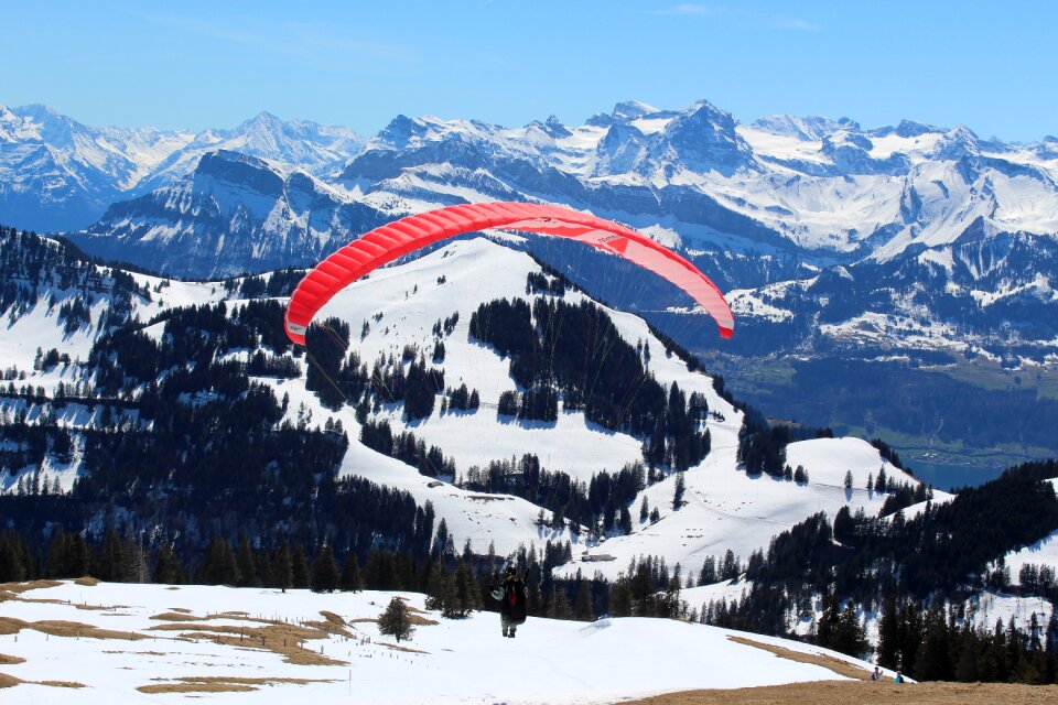 Paraglider winter scape switzerland