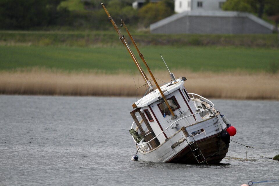 Sunken shipwrecked gray boat