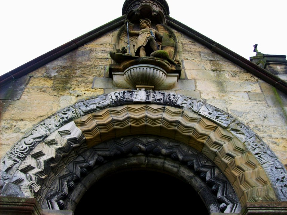 St Michael and All Angels, Barton-le-Street, carving over North porch