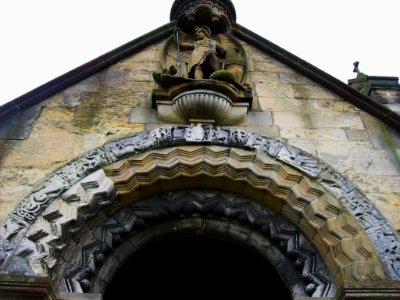 St Michael and All Angels, Barton-le-Street, carving over North porch