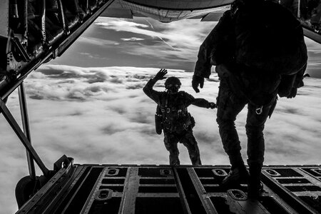 Jumping parachutist skydiving