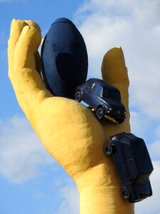 Yellow hand sculpture car