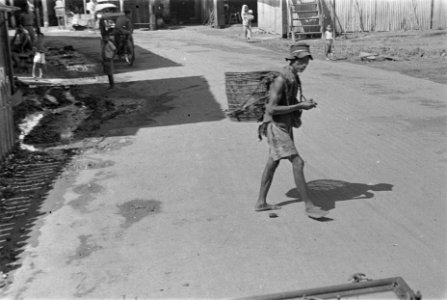 Straatbeeld Palembang. Indonesische man met mand op zijn rug, Bestanddeelnr 125A-1-4