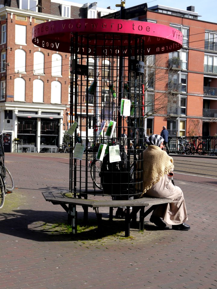 Street- furniture for Found Objects, with sitting Moroccan women on the bench, in the street Kinkerstraat, Amsterdam, 2014