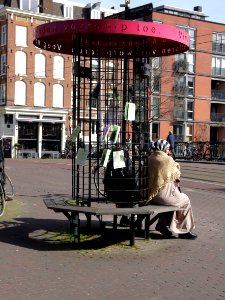 Street- furniture for Found Objects, with sitting Moroccan women on the bench, in the street Kinkerstraat, Amsterdam, 2014 photo
