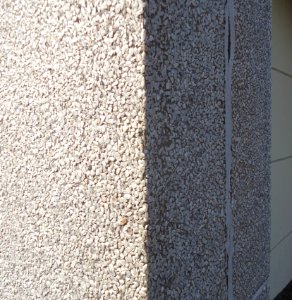 Surfaces vertical wall stone pattern side of a building closeup view photo