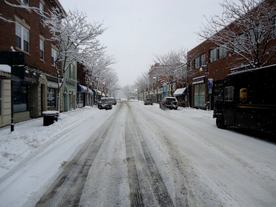 Summit New Jersey after snowfall with UPS truck trees cars buildings