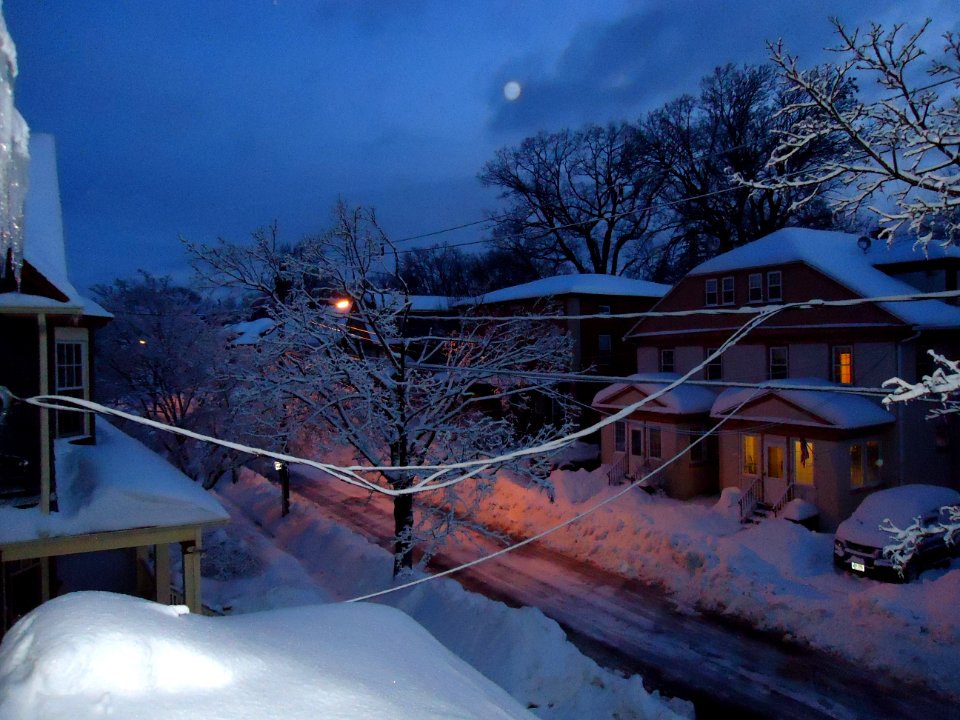 Summit New Jersey street after snowfall in early morning with houses and porches and car and moon