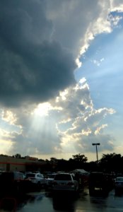 Sun breaking through clouds over a parking lot in NJ