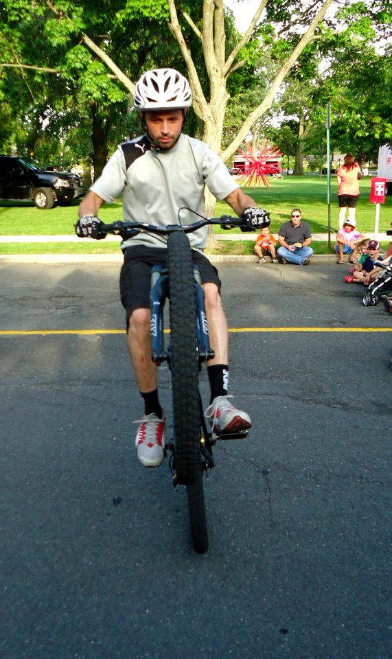 Stunt bicyclist Chris Clark demonstrates a wheelie in Summit NJ
