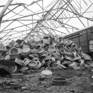 Stapels rieten manden in een geruineerde loods, Bestanddeelnr 900-7196