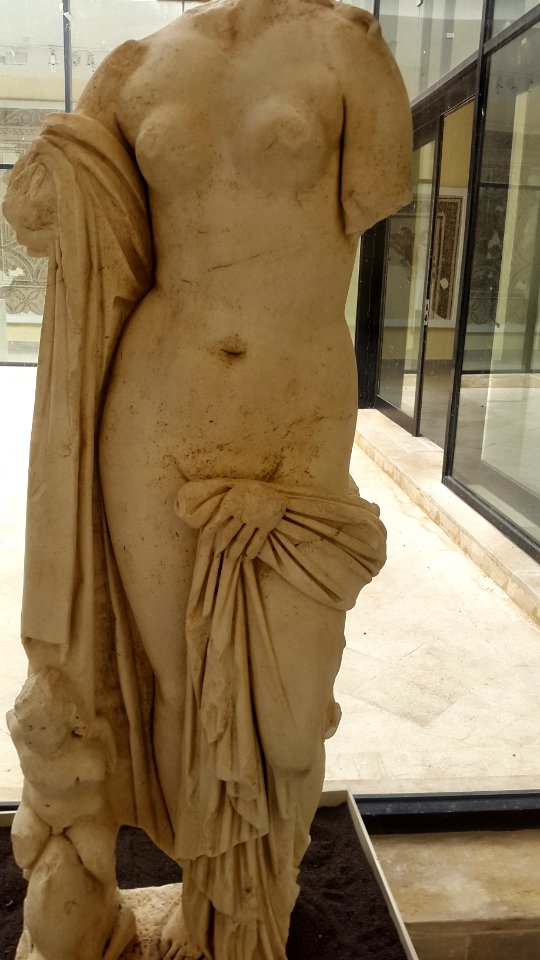 Statue of chaste goddess Venus accompanied by love figurine