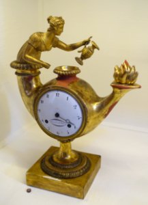 Table clock in form on an antique oil lamp, Empire style based on French original, dial signed Jonas Cederlund, Stockholm, early 1800s, carved gilt wood - Nordiska museet - Stockholm, Sweden - DSC09970