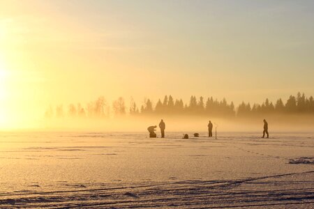 The fisherman on the ice on a winter day