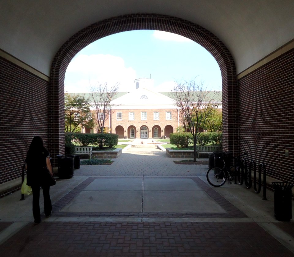 TCNJ The College of New Jersey archway and student
