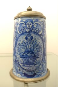 Tankard with fruit basket, putto mascaron, flower, and leaf decorations, tin mounting by Kordenbusch, Nuremberg, c. 1725-1740, earthenware - Stadtmuseum Fembohaus - Nuremberg, Germany - DSC02288