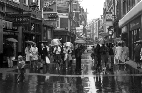 Toeristen in de regen van Amsterdam, mensen met paraplus in winkelstraat, Bestanddeelnr 926-5408