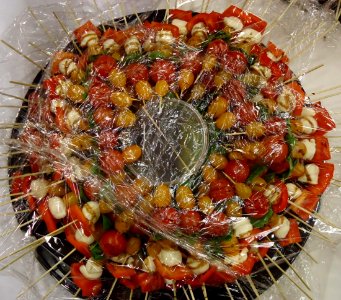 Tomatoes and cheese and olives on sticks at a party
