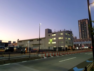Tokyo 2020 Olympics in Ariake, police watching on top of industrial building in front of tennis center court