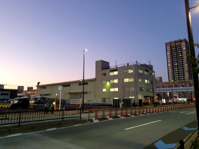 Tokyo 2020 Olympics in Ariake, police watching on top of industrial building in front of tennis center court photo