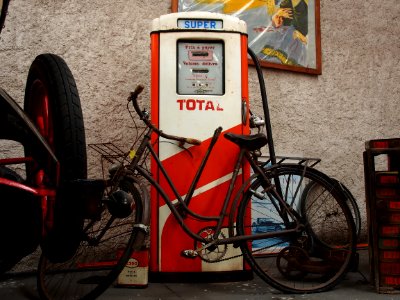 Total, old petrol pump with bicycle parked in front of it, pic2
