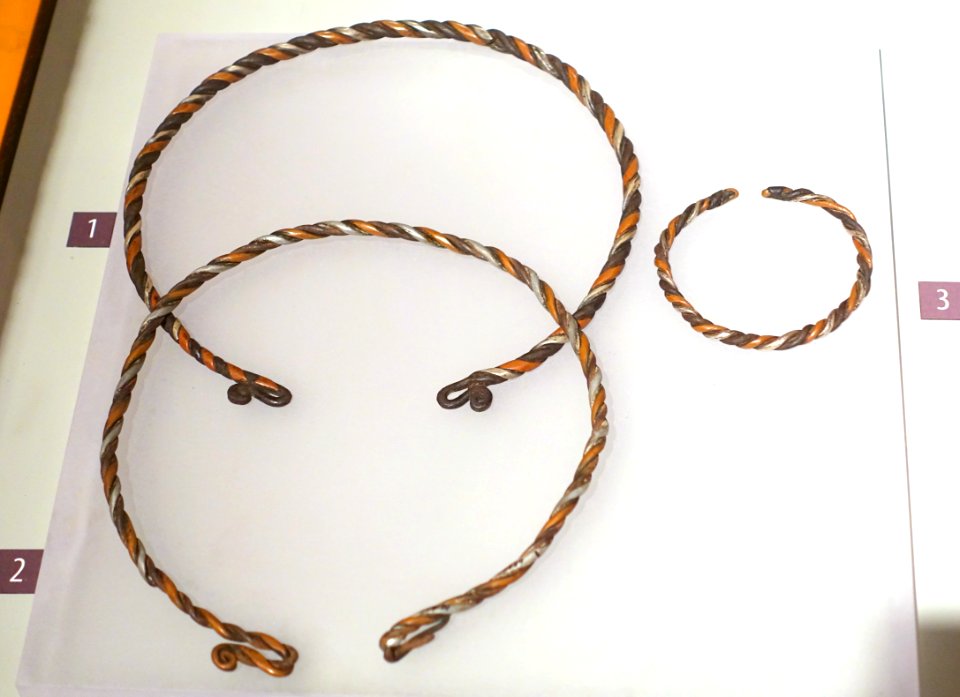 Torques and bracelet made by a shaman for Mrs Mua Y Dia, Green Hmong, Pa Co, Mai Chau, Hoa Binh, 1989, silver and other metals - Vietnamese Women's Museum - Hanoi, Vietnam - DSC04435