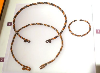 Torques and bracelet made by a shaman for Mrs Mua Y Dia, Green Hmong, Pa Co, Mai Chau, Hoa Binh, 1989, silver and other metals - Vietnamese Women's Museum - Hanoi, Vietnam - DSC04435