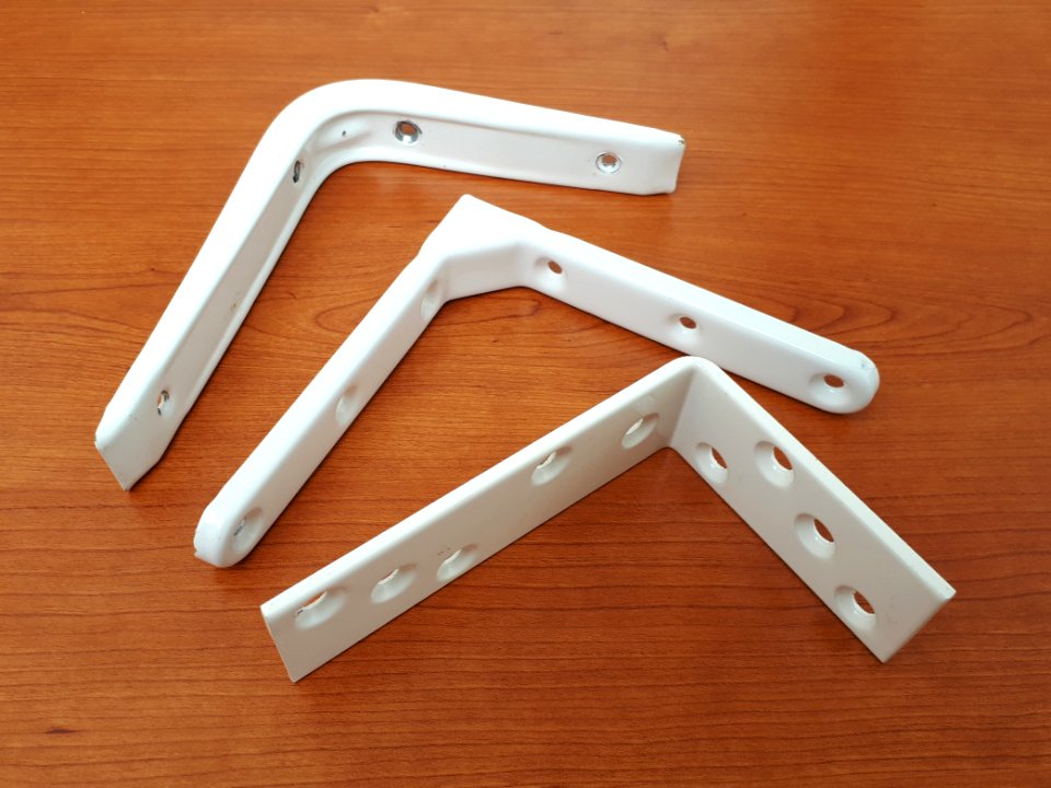 Three white metallic shelf brackets - A