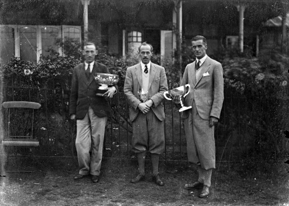 Three men holding trophies (1293763)