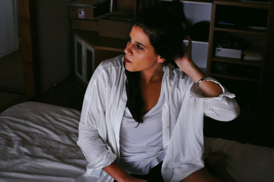 Person woman gray bed