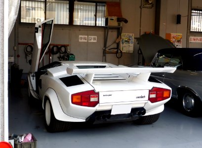 The rearview of Lamborghini countach LP400 with its driver side door opened