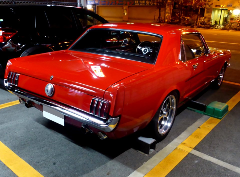 The rearview of Ford Mustang MY1965 at night