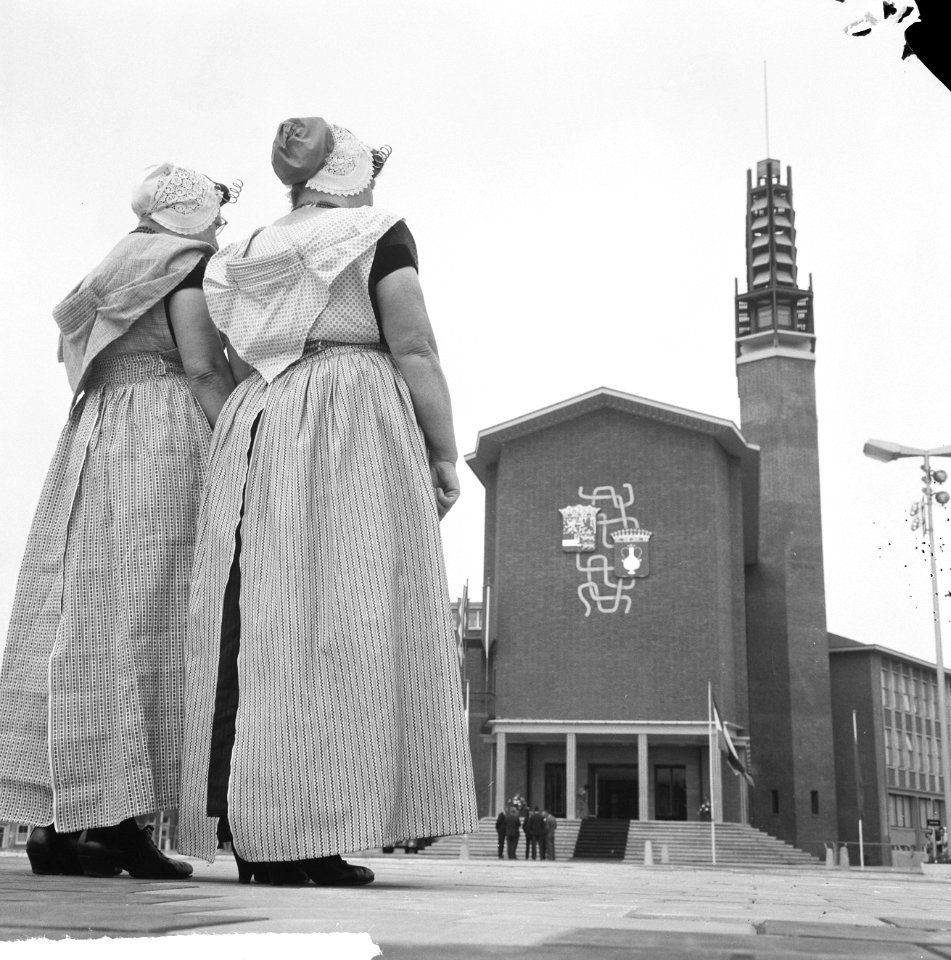Twee vrouwen in Klederdracht staan voor het nieuwe stadhuis, Bestanddeelnr 917-7971
