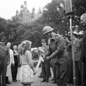 Twee meisjes bieden majoor van het regiment Stoottroepen een boeket bloemen en e, Bestanddeelnr 900-7809