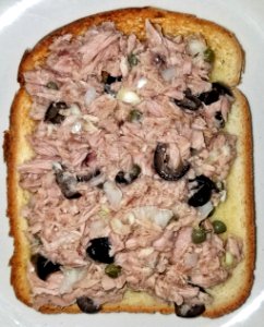 Tuna sandwich with black olives, capers, onion, garlic, lemon juice, olive oil, and kosher salt on buttered white toast - Massachusetts